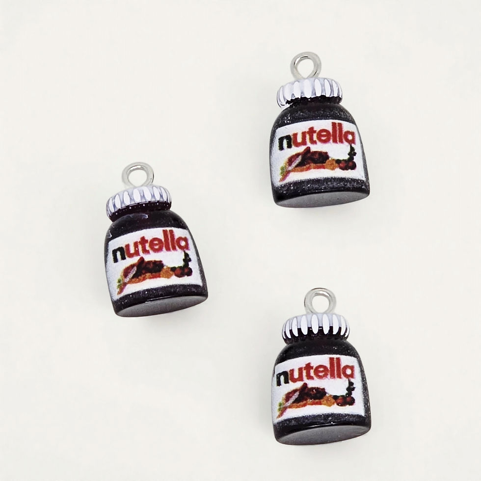 hazelnut spread charm made of resin on plain background