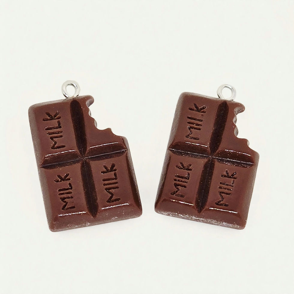 milk chocolate bite charm made of resin on plain background
