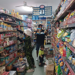 Gloria helps withteh unpack of the weekly supplies at the Ayton store