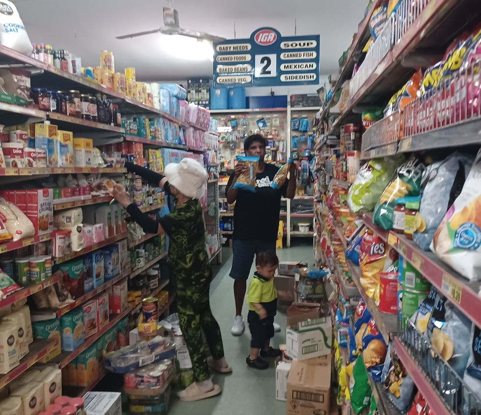 Gloria helps withteh unpack of the weekly supplies at the Ayton store