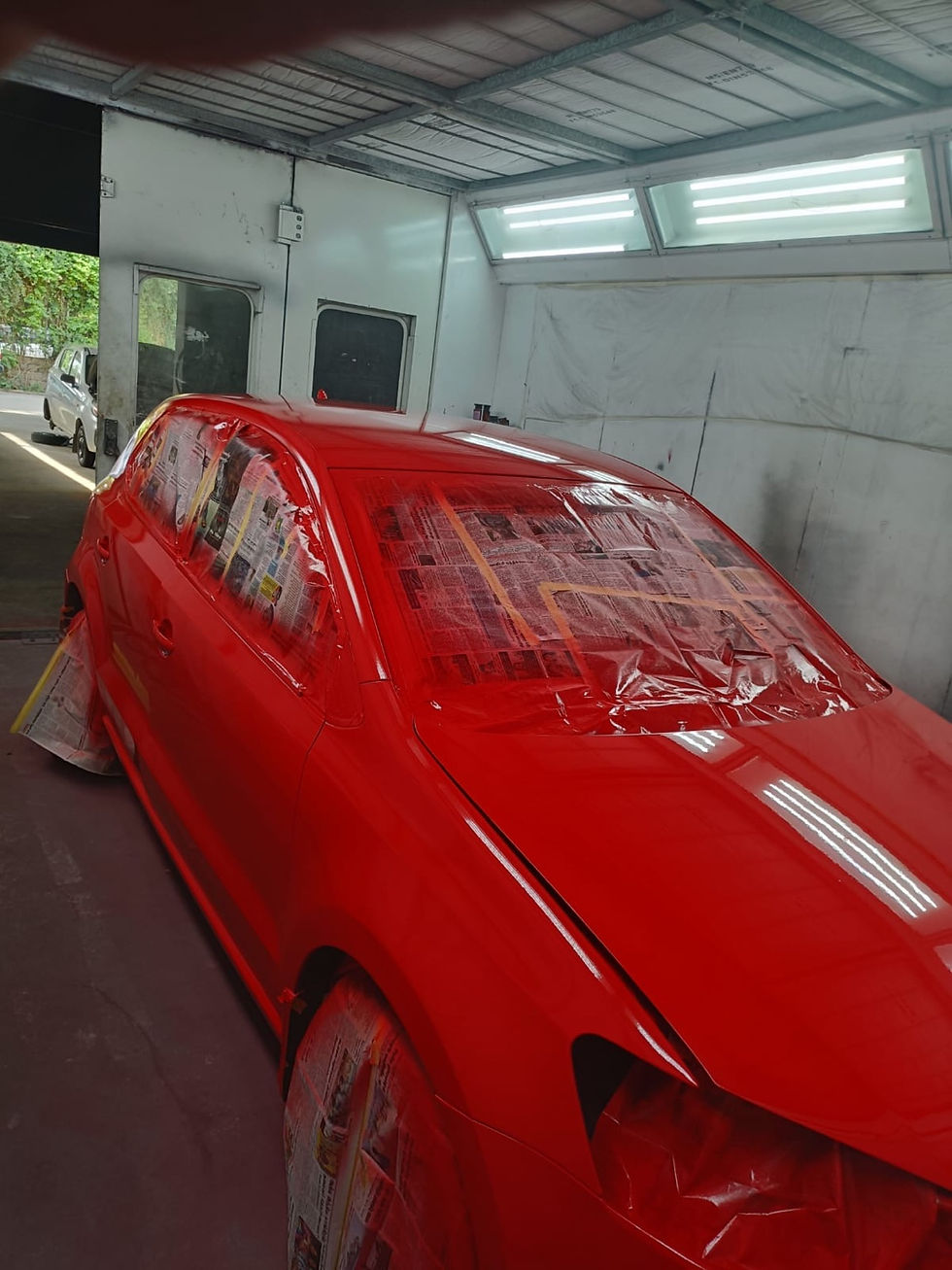 Masked Volkswagen Polo prepared for premium red full body paint