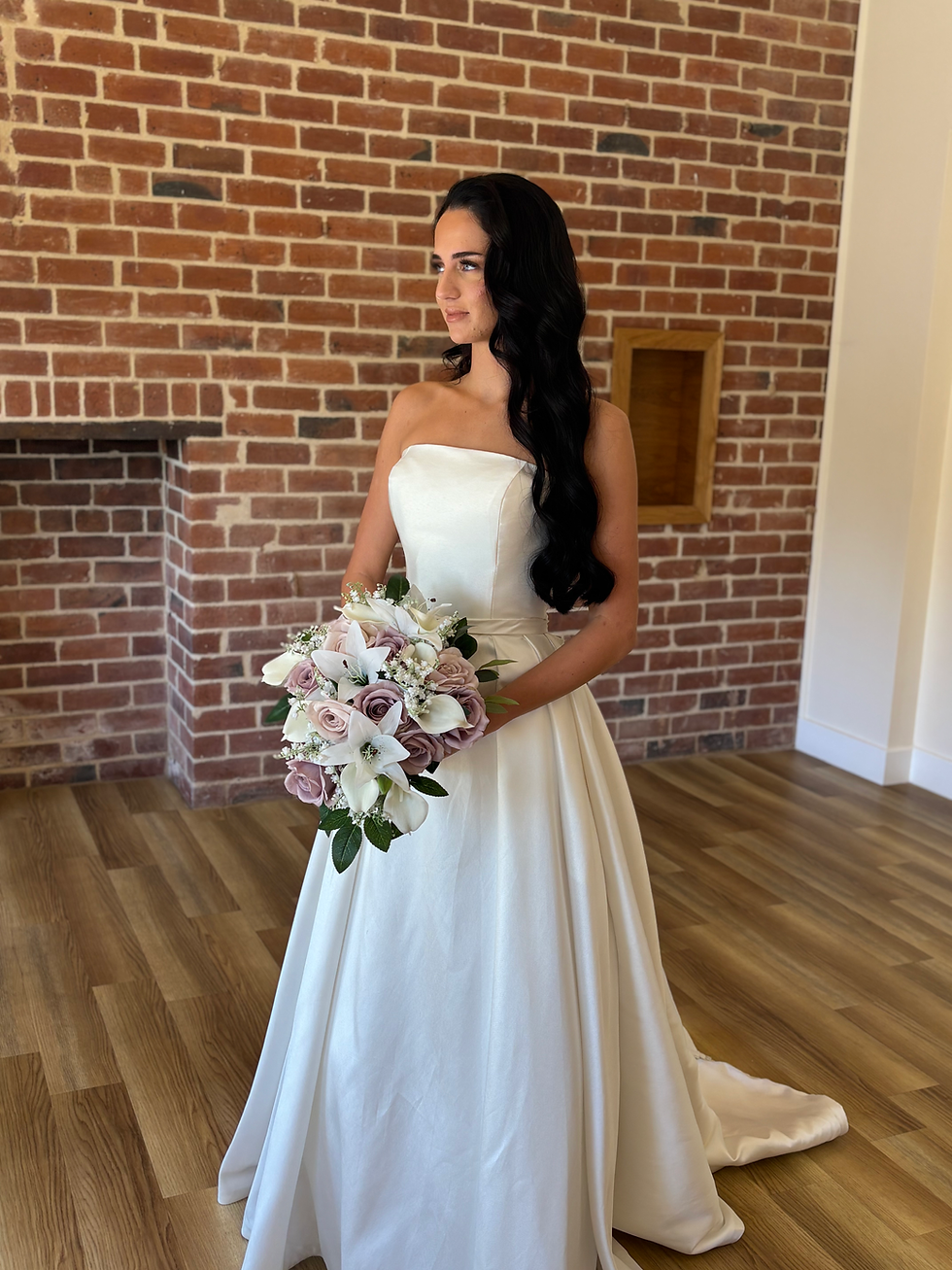 Thumbnail: Light Purple and White Lily Cascading bride in shot holding the bouquet