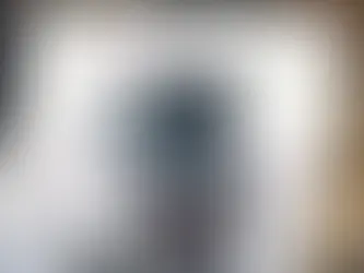 A video camera recording a website video with a white studio backdrop