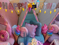 Happy Birthday banner, pillows, and teepee, Candyland Sleepover Theme, dessert-themed decorations inside