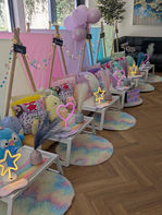 Colourful sleepover setup with pillows and decorative lights.