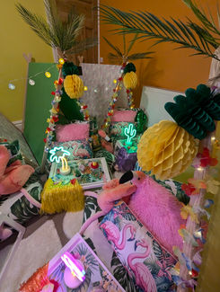 a room decorated with flamingos and palm trees