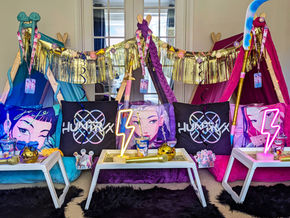 Colourful KPop indoor setup with themed pillows and decorations.