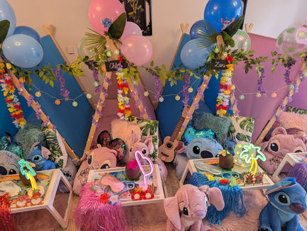 Colourful party setup with balloons, plush toys, and decorations.