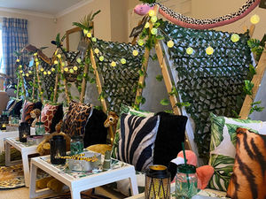 Jungle-themed party with tent, balloons, and stuffed animals; Safari Adventure Sleepover Theme
