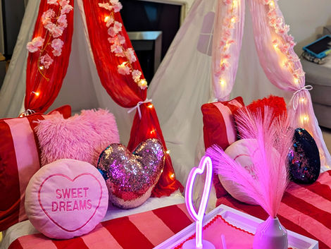 Two decorated teepee tents, "SWEET DREAMS" pillow, galentines girls sleepover party theme.