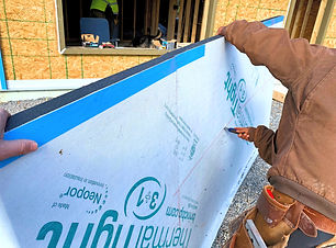 Contractor cutting ThermalTight panel with box cutter