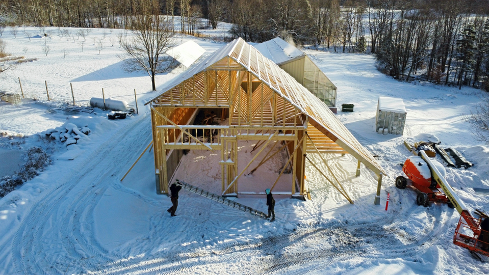 Framing of new 1736 sq ft warehouse next to existing greenhouse.