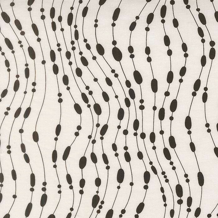 white fabric with black beaded pattern