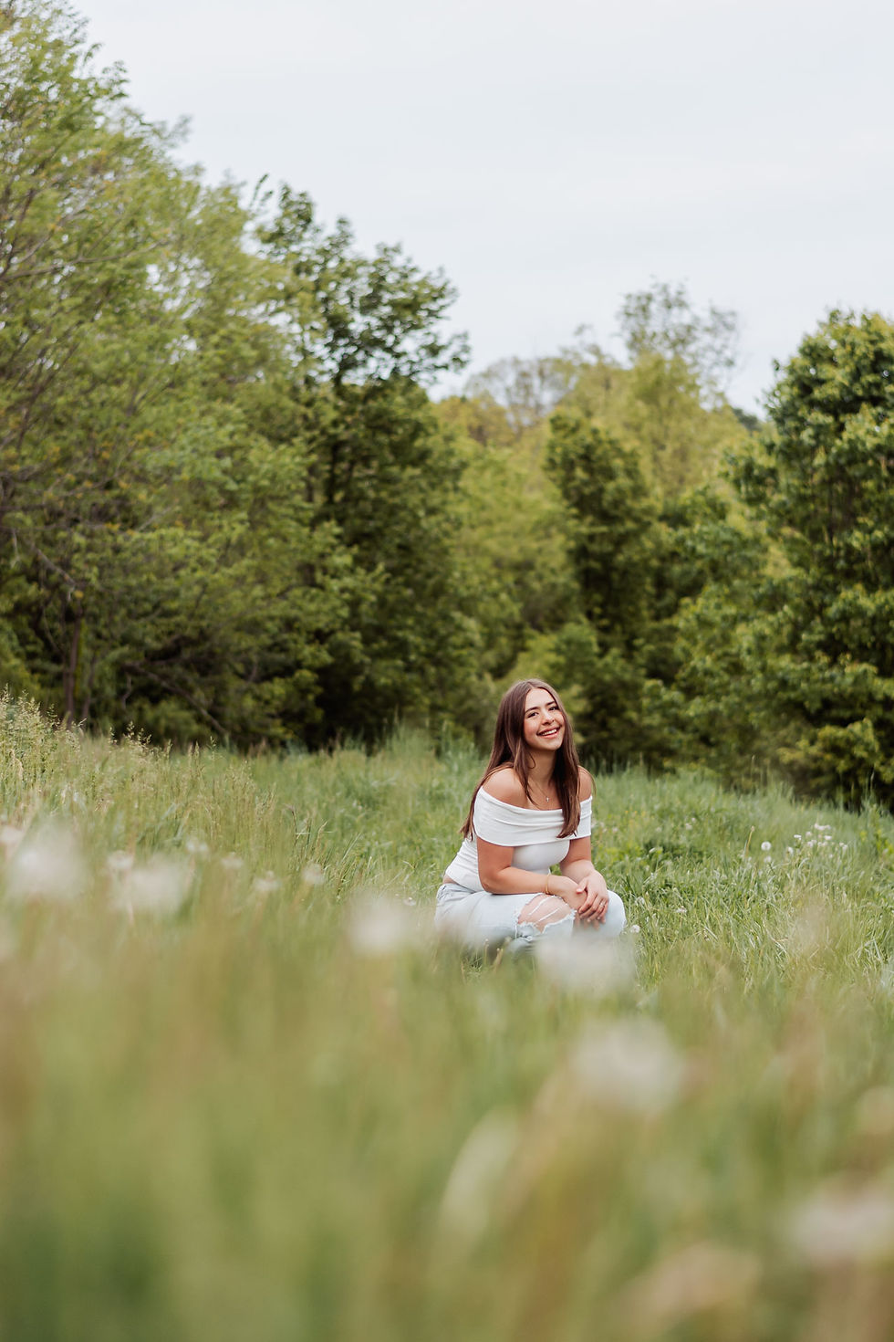 a senior girl smiles for her senior portraits in upper st clair at boyce mayview park