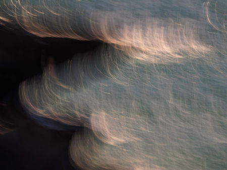 Light reflects off the ocean along the Pembrokeshire coastline, Wales.