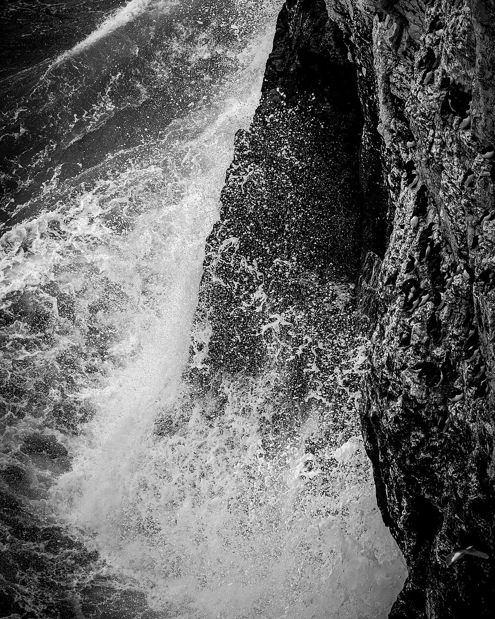 Wild waves crash against the dramatic Yorkshire coastline at RSPB Bempton Cliffs.