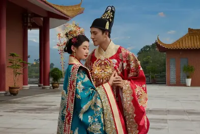 The couple poses in traditional Chinese attire on a temple terrace during their pre wedding photoshoot.