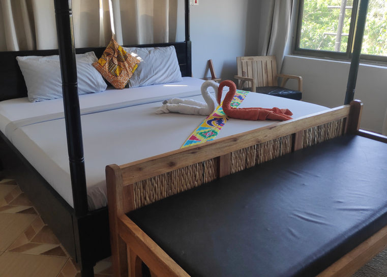 Four poster king size bed in bedroom in Elmina