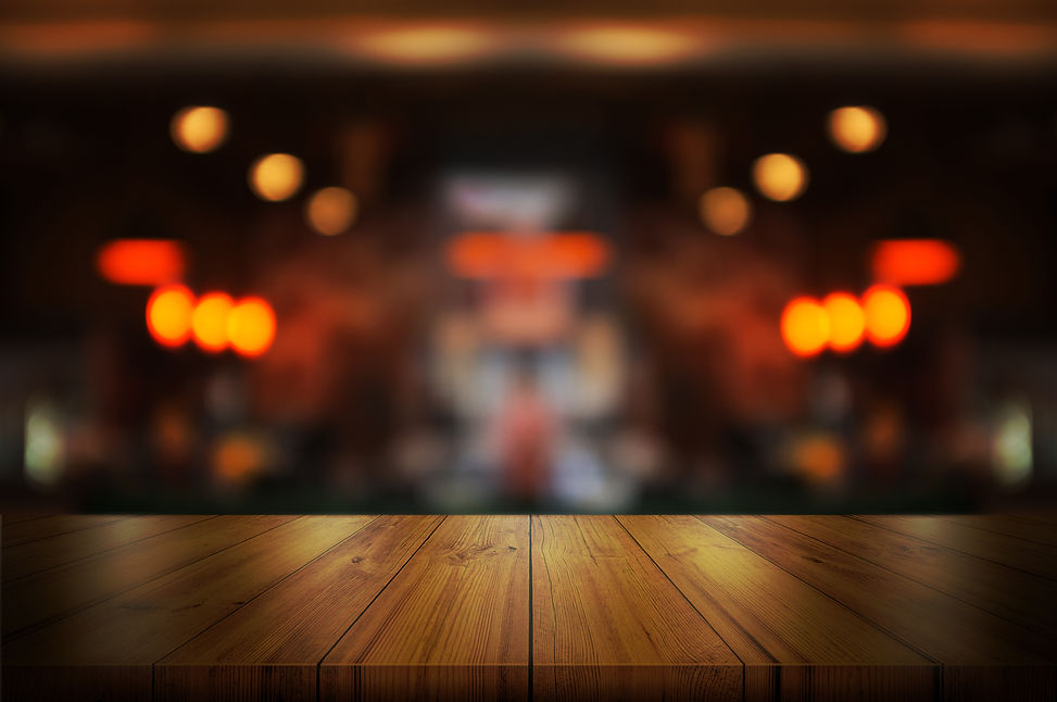 empty-wooden-table-top-with-blurred-coff