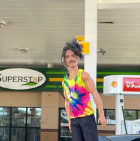 Barbie Paul posing with Superstar gas station