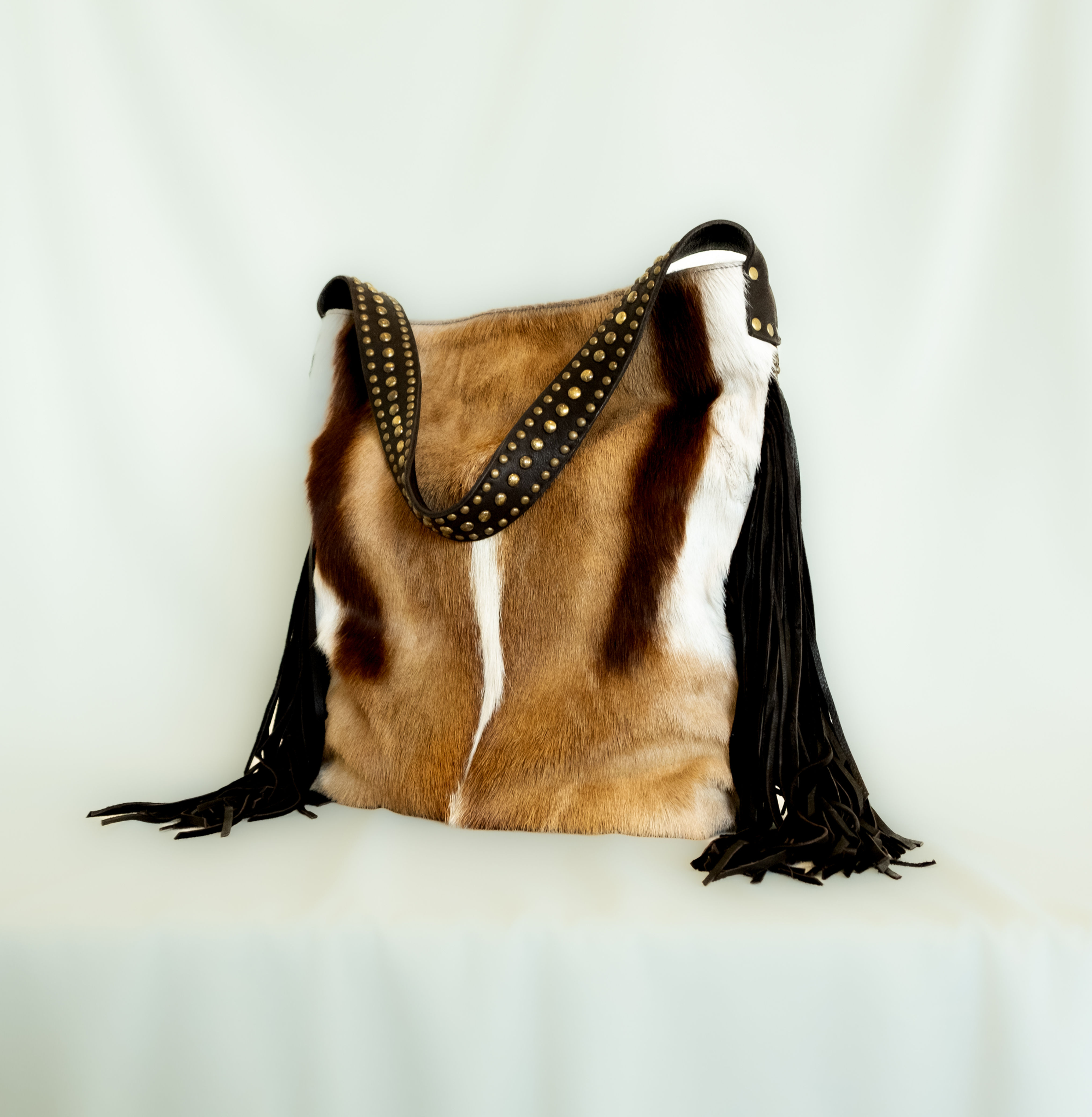 2016H - Hair on antelope with dark brown leather fringes and trim