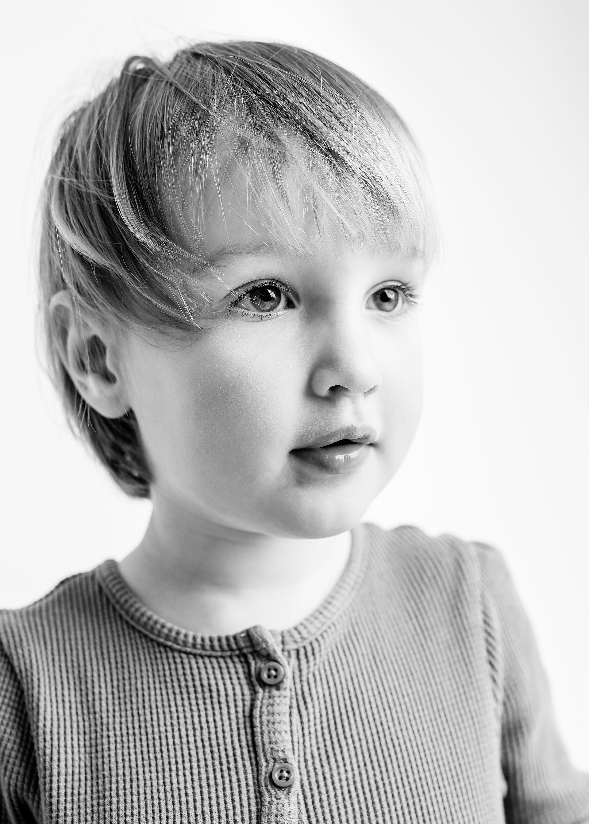 Black and white portrait of a kid on a light background