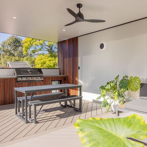 Contemporary pool cabana featuring Spotted Gum hardwood, James Hardie V-groove cladding, Trex Biscayne decking laid diagonally, and a Versiclad insulated pergola on aluminium beams. Includes a custom BBQ area with polished concrete bench and bar fridge.
