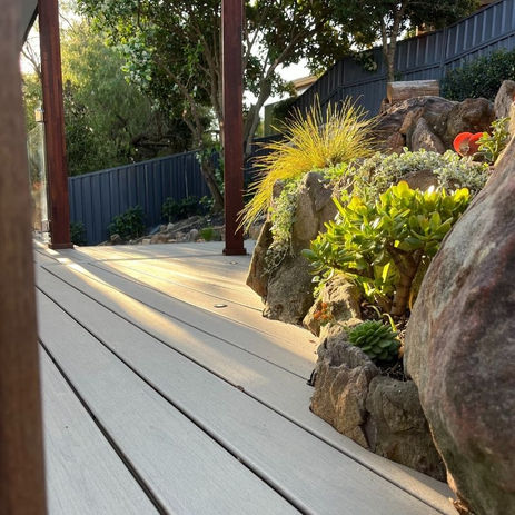 Trex Biscayne deck with in-built lighting and detailed finish around natural rockwork — Bangor.