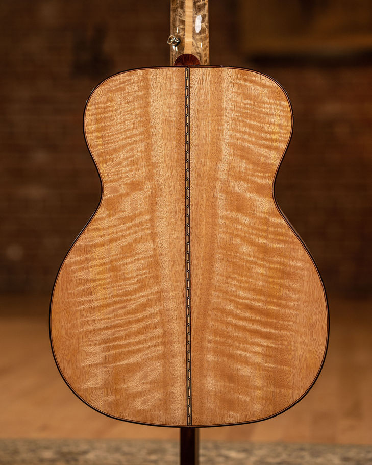 Close-up of a guitar's back made with Premium Figured Mahogany Boards.