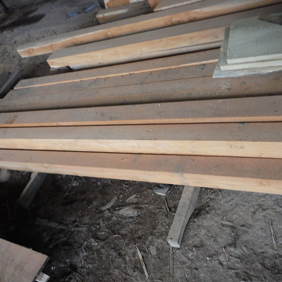 Wood planks stacked, 48" x 6" x 1/8" Teak Veneer, Yacht Decking, Sanded, All Heartwood, Kiln D, in a workshop.