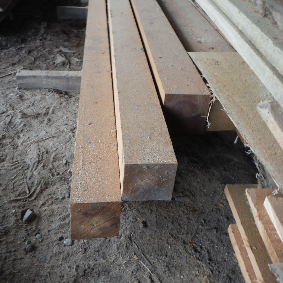 Three wooden beams stacked, construction material in a lumberyard Diamond Tropical Hardwoods
