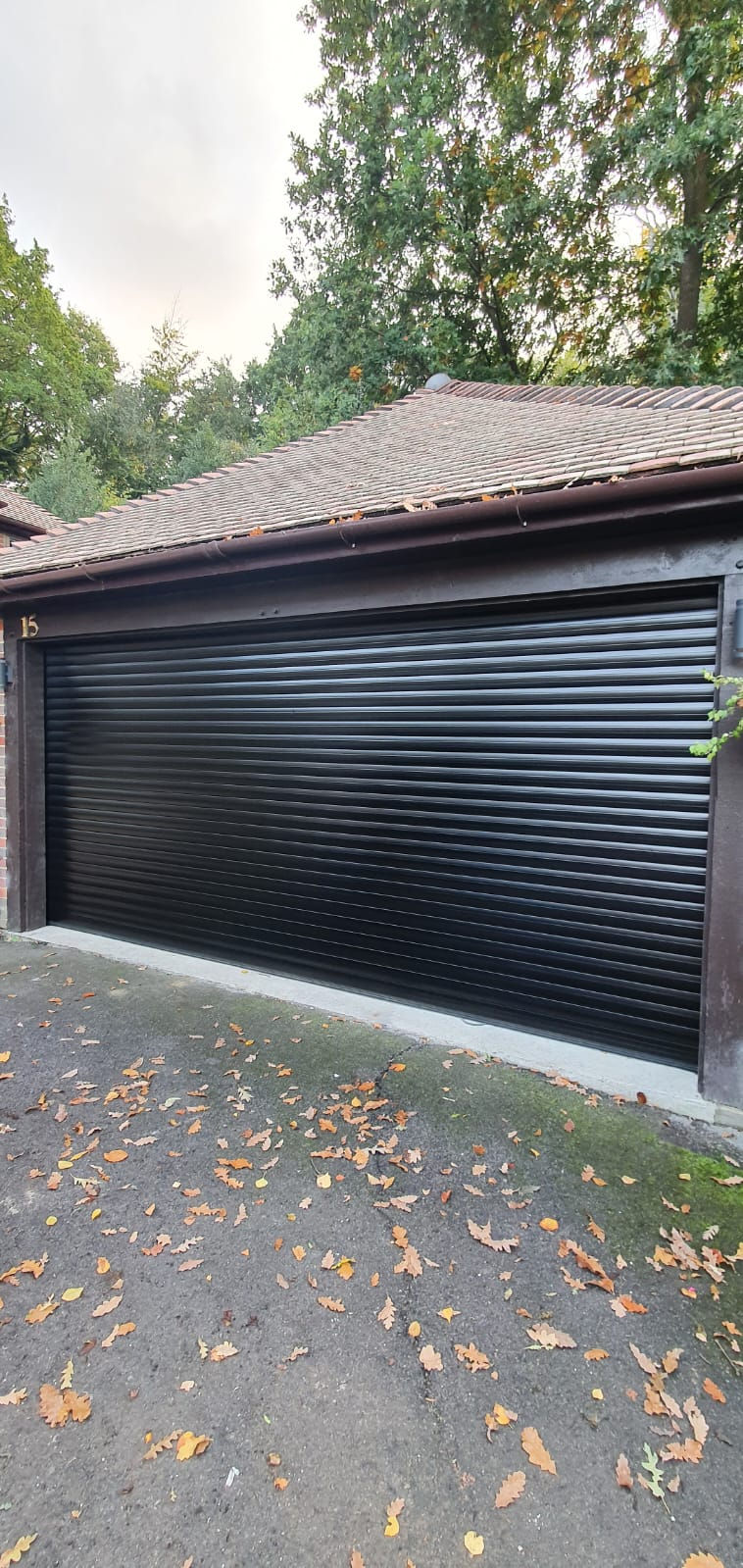 Dark sectional garage door after professional respraying
