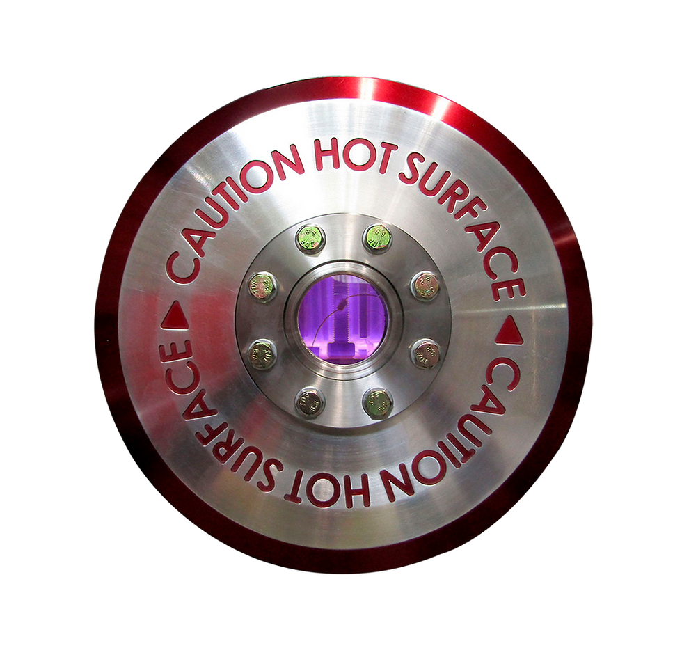 Plasma nitriding process seen through the viewport of an ION HEAT furnace, with visible glow discharge inside the chamber.