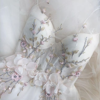Tulle bridal gown with soft pink and white floral embroidery