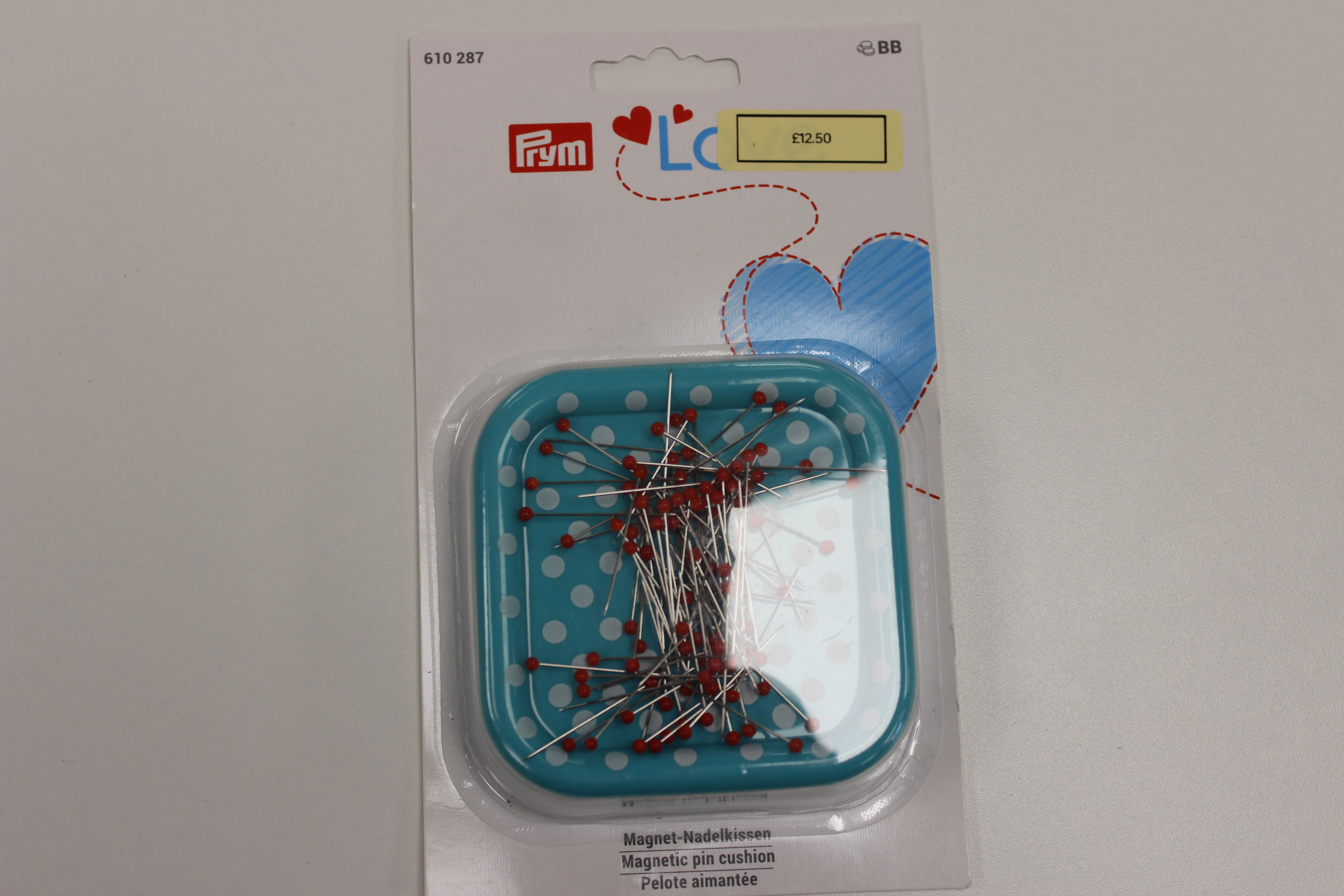 Magnetic pincushion with glass-headed pins