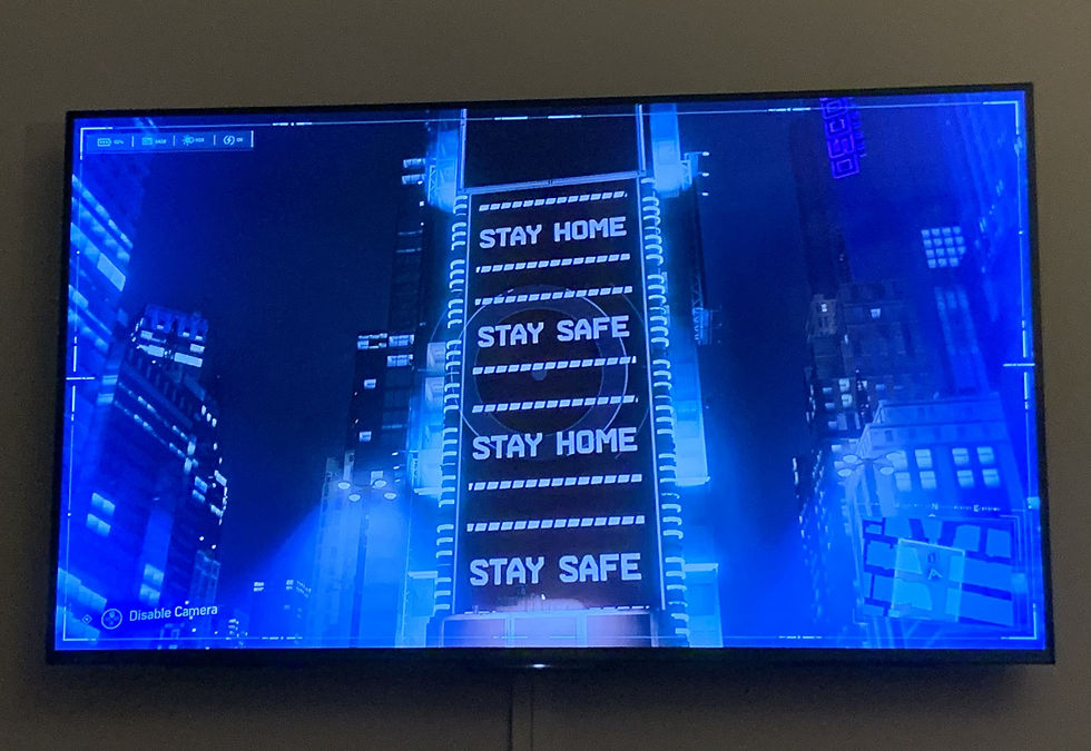 A picture of a neon tower in Spider-Man PS4 reading 'Stay Safe, Stay Home'