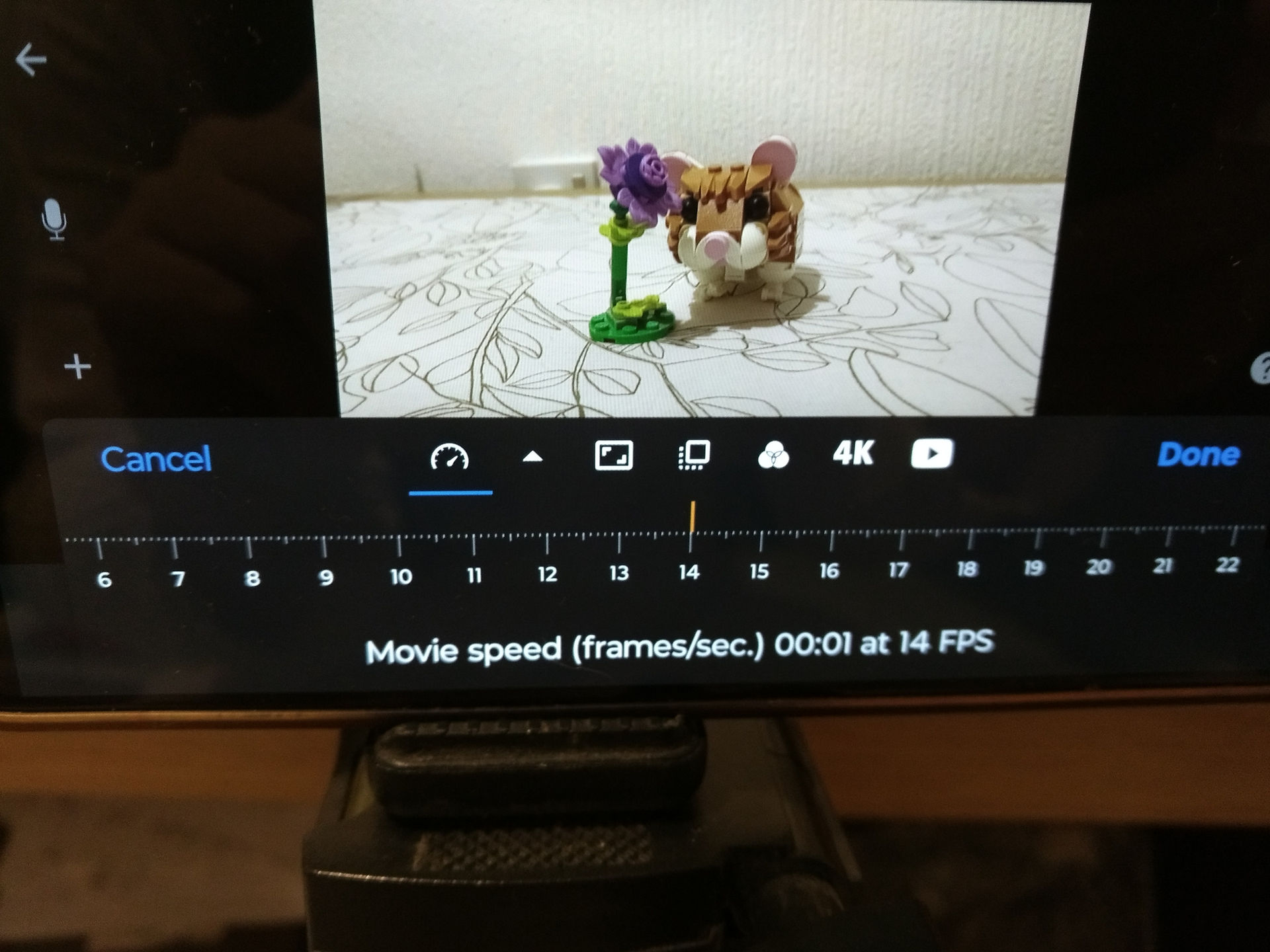 mobile phone screen showing how many shots per second to film in with a picture of a Lego hamster and flower