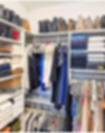 Eye-level view of a neatly organized closet with color-coordinated clothing