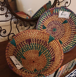 Two handmade colorful baskets or bowls made by Ugandan women