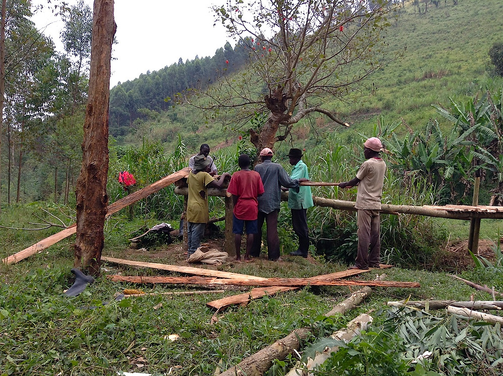 The men of Karehe work on the bridge's construction
