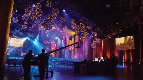 Youth collaborating on stage production and live event setup activities.