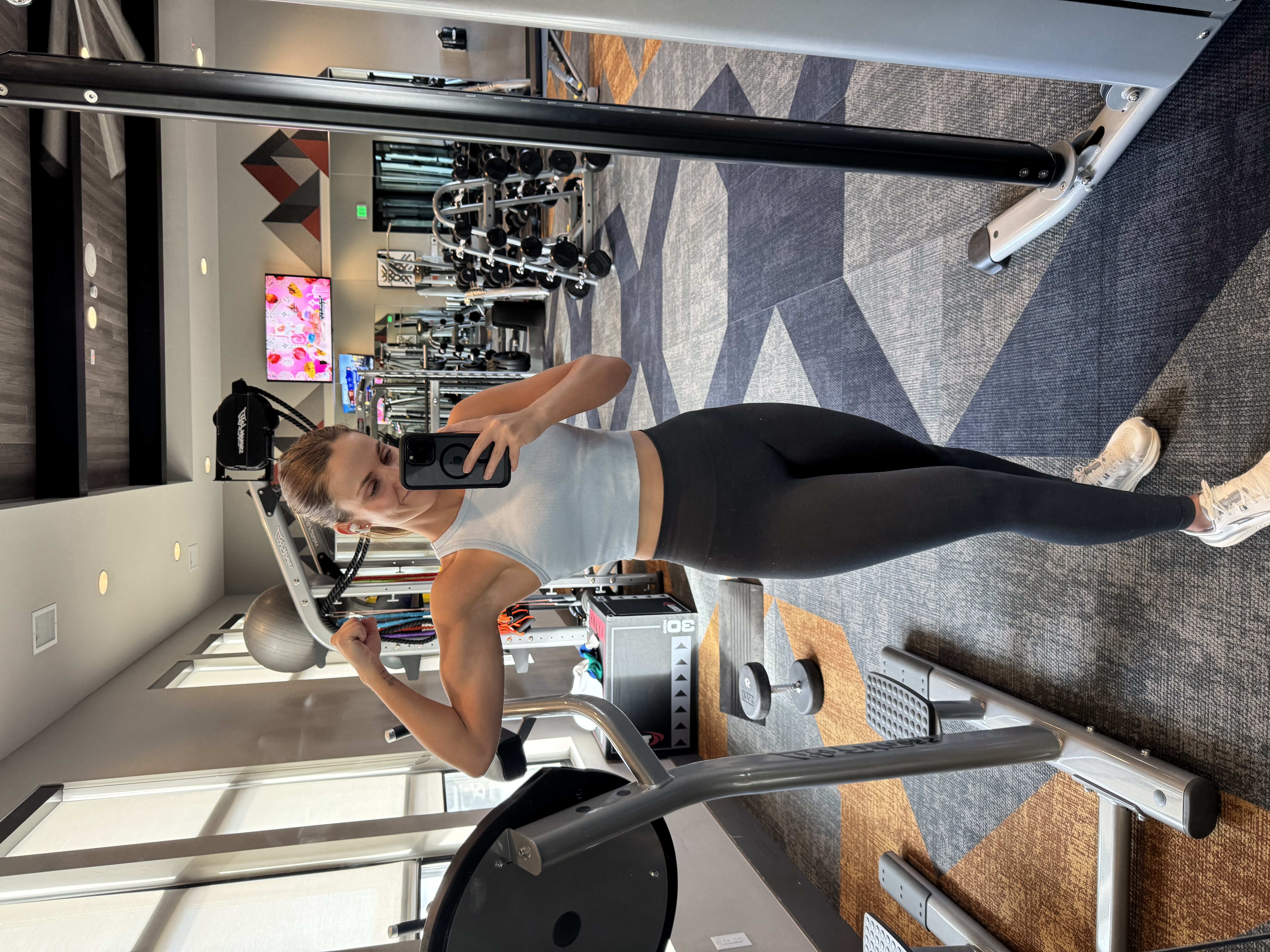 Tyra flexing her arm in the gym