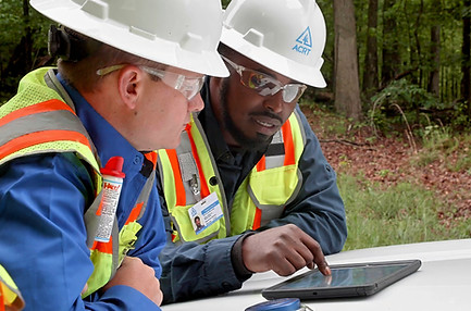 on the job training by a truck with a tablet and two men