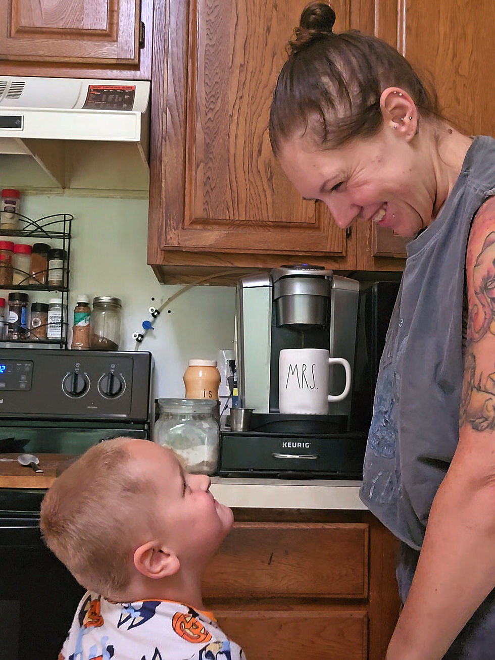 mom and son holding hands and looking at each other