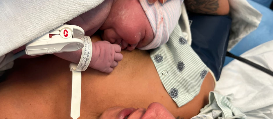 woman holding her baby in arms after a c-section