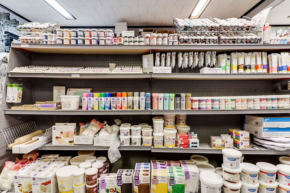 Decorators' Grocery display of sprinkles, food color spray, and icing
