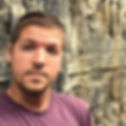 Timm, author, creator and travel blogger of Llama Socks Travel Guide posing for a selfie at some ancient ruins in Cambodia. He is a solo gay male traveler.