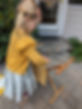 Image of a child hanging clothing up on a drying rack.