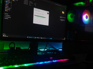 Desktop computer, monitor and keyboard illuminated with colored lights