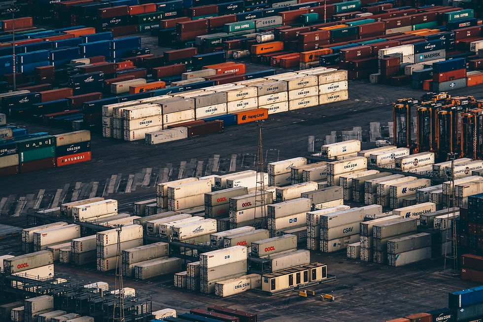 Stacks of shipping containers at a busy cargo port